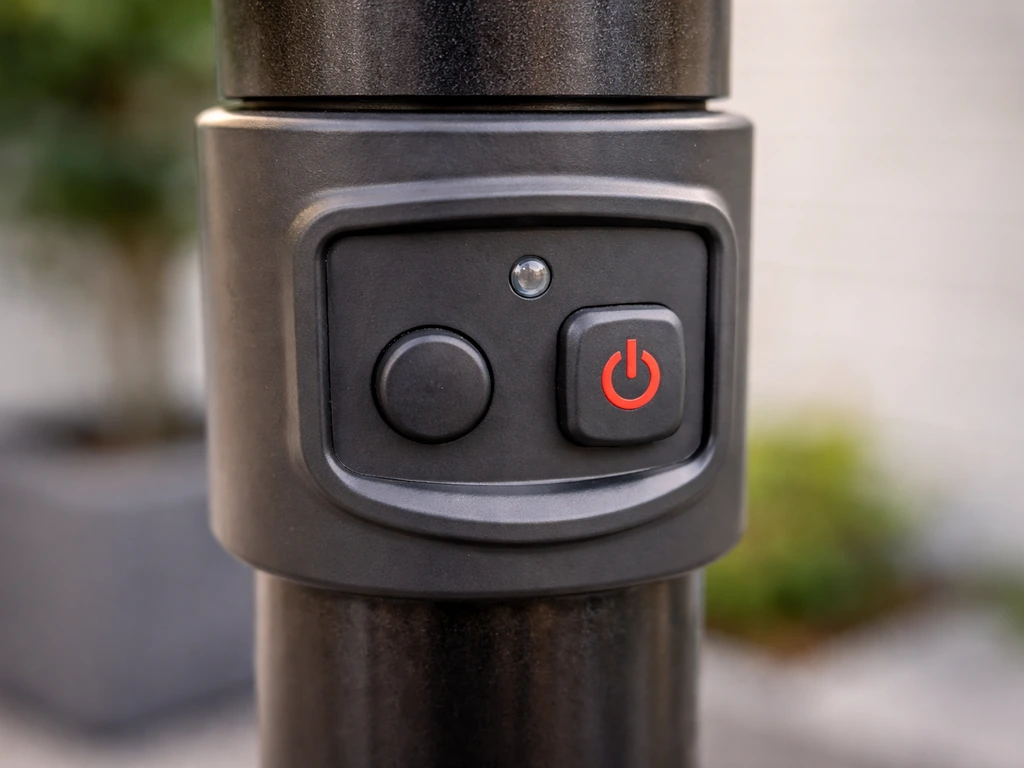 Close-up of an outdoor electric patio heater control panel with heat on/off buttons and small LED indicator.